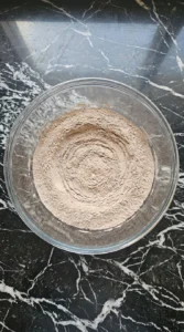 Whisking flour and cocoa powder in a clear glass bowl