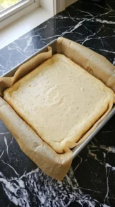 Baking Banana Cheesecake Bars in the pan until set Recipe focus: symboles.