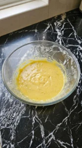 Adding egg and banana to the dough mixture for Banana Pudding Cookies