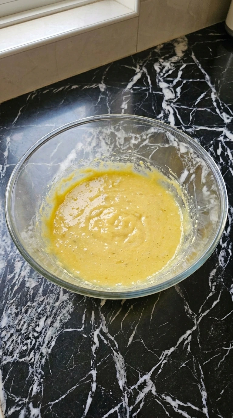 Adding egg and banana to the dough mixture for Banana Pudding Cookies