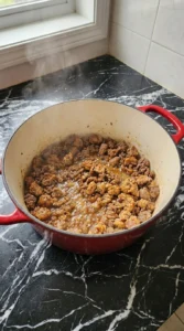 Browning ground beef and sausage for Boilermaker Tailgate Chili: The Hearty One-Pot Game Day Recipe Recipe focus: Boilermaker Chili Recipe.