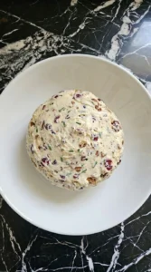 Shaped Cranberry Pecan Cheese Ball chilling as a 6-inch uneven round