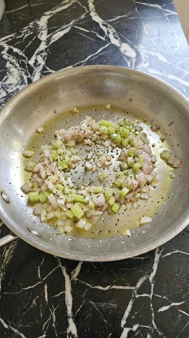 Softened shallot and celery for Cranberry Pecan Wild Rice in a skillet