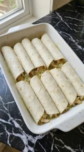 Rolling flour tortillas for Creamy Hatch Green Chile Chicken Enchiladas