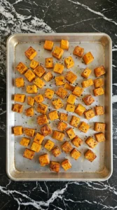 Fall Pasta Salad Recipes with Cozy Harvest Flavor step showing 1-inch butternut squash cubes roasted to deep amber edges.