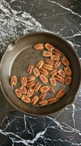 Fall Pasta Salad Recipes with Cozy Harvest Flavor step showing pecan halves toasted to a warm brown color.