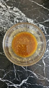 Fall Pasta Salad Recipes with Cozy Harvest Flavor step showing glossy amber maple Dijon dressing fully whisked.