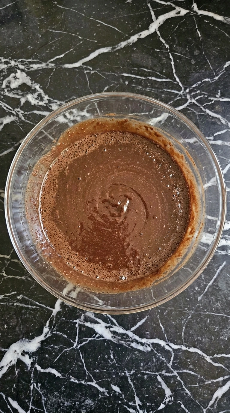 Fudgy Chocolate Zucchini Brownies (No One Will Guess!) step showing a glossy warm chocolate and egg mixture