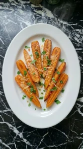 Garlic Parmesan Roasted Carrots plated as one serving with parsley and toasted cheese