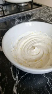 Whipping chèvre for Goat Cheese and Fig Jam Appetizer for Easy Entertaining into a smooth white spread