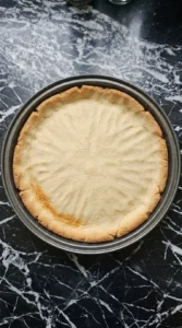 Golden baked crust for Halloween Fruit Pizza with Sugar Cookie Crust cooling in the pan
