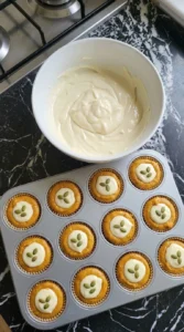 Smooth cream cheese filling for pumpkin muffins in a white bowl.