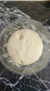 Neapolitan Pizza Dough Recipe (Easy Authentic Napoli-Style Crust) step 4 showing a rounded proofed dough ball