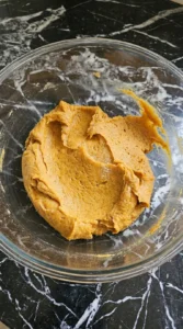 Mixing spiced dough for Pumpkin Cheesecake Cookies