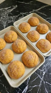 Golden baked Pumpkin Cheesecake Cookies on a sheet pan