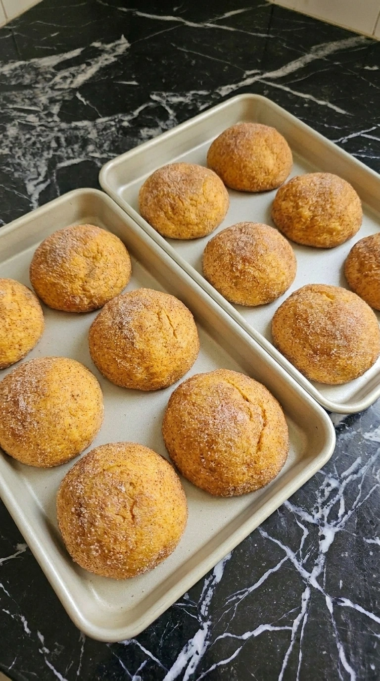 Golden baked Pumpkin Cheesecake Cookies on a sheet pan