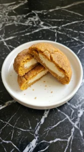 Split Pumpkin Cheesecake Cookies showing the cream cheese center