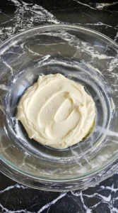 Pumpkin Cream Cheese Danish step showing thick pale cream cheese filling in a glass bowl