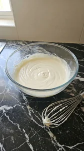 Mixing cream cheese filling in a glass bowl for a Raspberry Danish