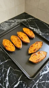 Roasted garnet sweet potato halves with caramelized orange flesh for Sweet Potato Gnocchi.