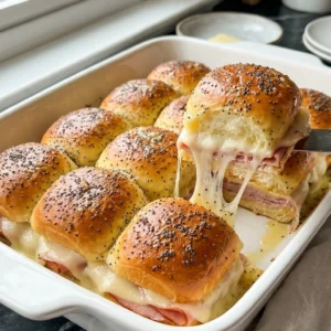 Sassy Tailgate Sandwiches: Hot Ham and Cheese Sliders for Game Day fresh out of the oven in a baking dish Recipe focus: Sassy Sandwiches.