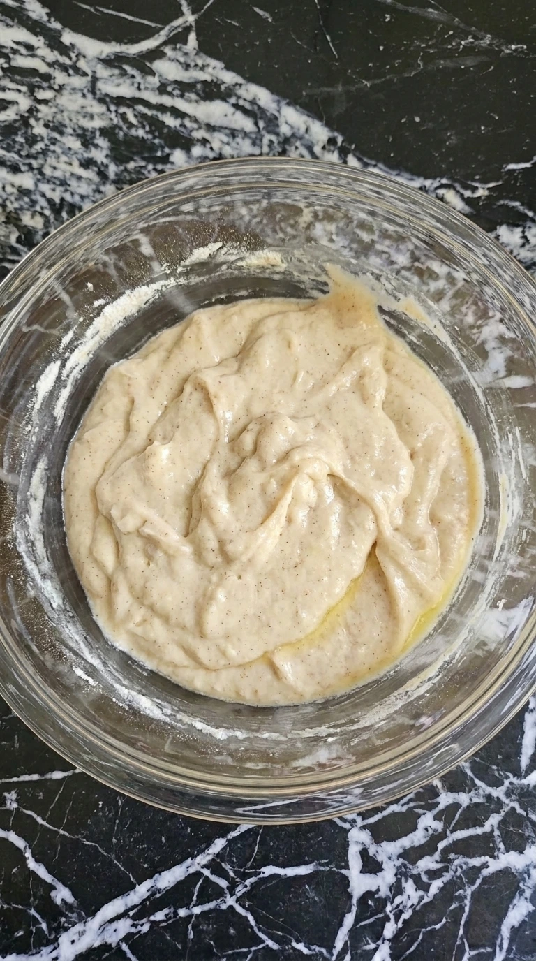 Slow Cooker Peach Cobbler with Fresh Summer Peaches step 2 with thick lumpy cobbler batter in a glass bowl