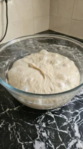 Folded and risen dough for Sourdough Discard Focaccia (Easy No-Waste Recipe) with visible bubbles