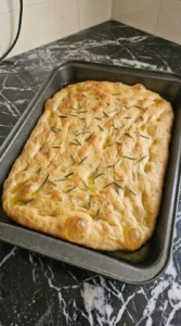 Baked Sourdough Discard Focaccia (Easy No-Waste Recipe) slice showing crisp edges and an airy crumb