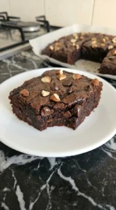 Single sweet potato brownie square showing its dense fudgy center.