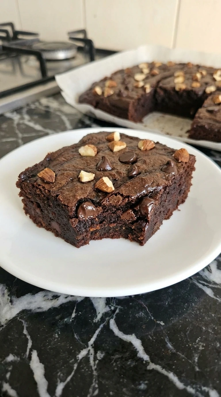 Single sweet potato brownie square showing its dense fudgy center.