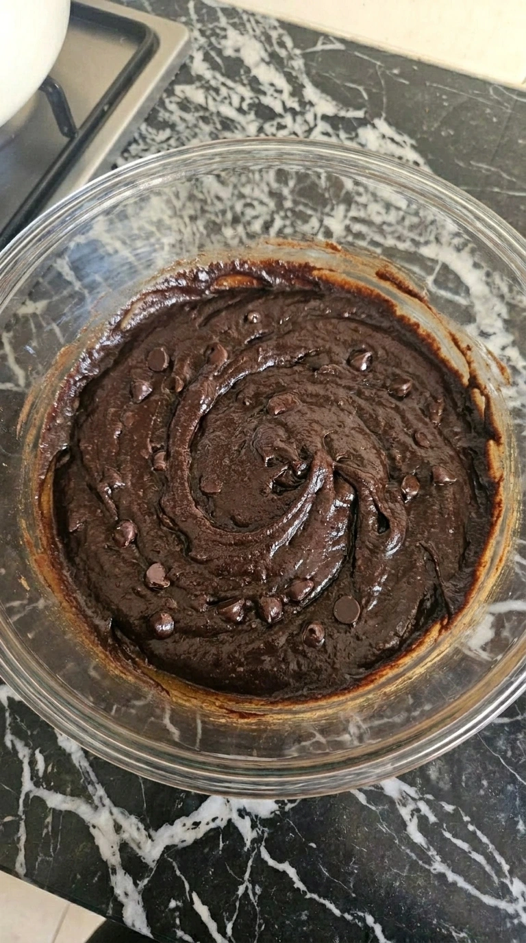 Thick cocoa sweet potato brownie batter with dark chocolate chips.