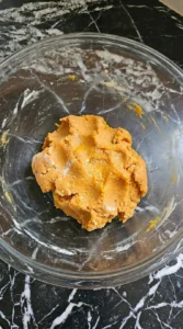 Soft orange Sweet Potato Gnocchi dough folded with 00 flour and Parmesan.