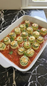 Freshly baked Zucchini Roll-Ups with bubbling cheese and golden spots