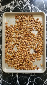 Golden amber Cinnamon Sugar Roasted Pumpkin Seeds roasting until crisp with darker caramelized edges