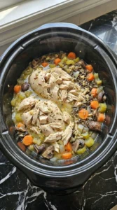 Shredded chicken folded into Crockpot Chicken and Wild Rice Soup with tender wild rice and vegetables Recipe focus: chicken wild rice soup crockpot.