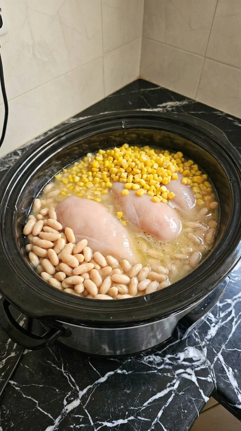 Crockpot Healthy White Chicken Chili step 1 with chicken beans and broth combined Recipe focus: white chicken chili with rotisserie.