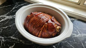 Crockpot Thanksgiving Ham with thick glossy glaze coating the slices Recipe focus: thanksgiving ham recipes crockpot.