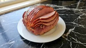 Crockpot Thanksgiving Ham sliced and plated for serving Recipe focus: thanksgiving ham recipes crockpot.