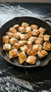 Easy Lemon Garlic Butter Chicken Bites searing with golden chicken pieces Recipe focus: honey garlic lemon pepper chicken thighs.