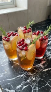 Friendsgiving Cocktails finished glasses with cranberry and apple garnish Recipe focus: friendsgiving appetizer party.