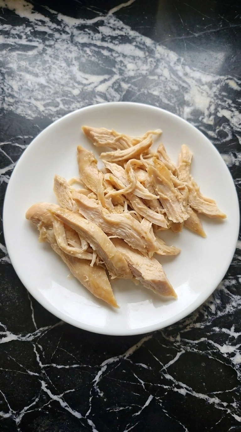 Tender shredded chicken prepared for Gluten Free Chicken Noodle Soup