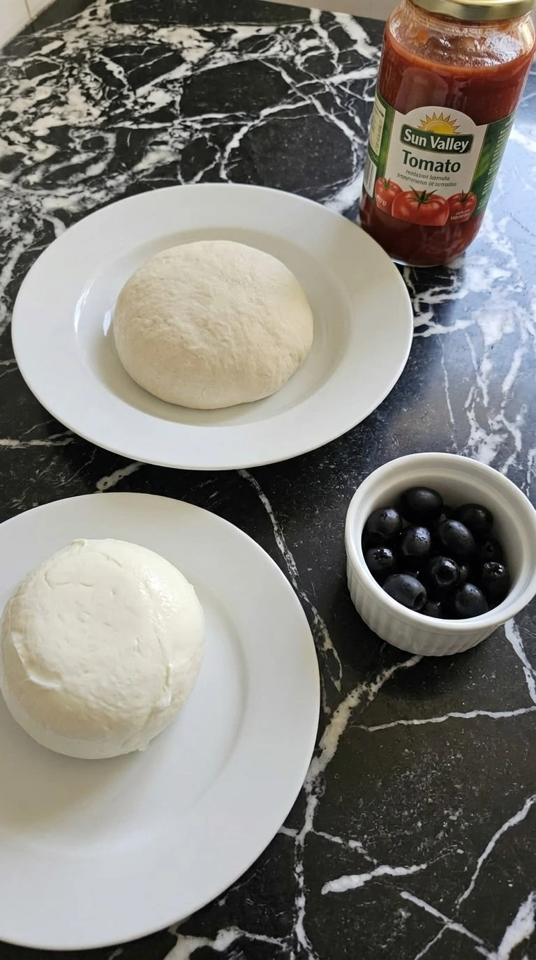 Halloween Appetizers Pizza ingredients including mozzarella and olives for ghost pizza