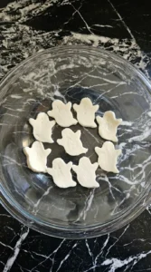 Halloween Appetizers Pizza mozzarella ghost shapes before baking