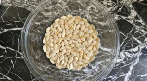 Roasted Pumpkin Seeds with Parmesan step one showing freshly rinsed pumpkin seeds with pulp Recipe focus: how to make roasted pumpkin seeds with parmesan.