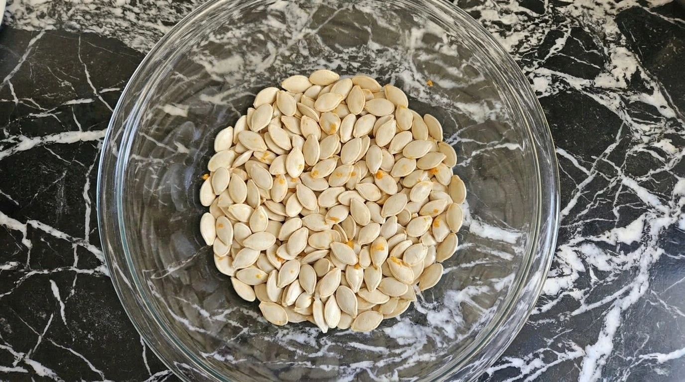 Roasted Pumpkin Seeds with Parmesan step one showing freshly rinsed pumpkin seeds with pulp Recipe focus: how to make roasted pumpkin seeds with parmesan.