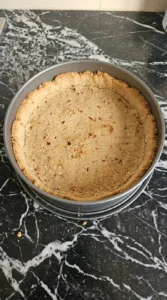Apple Crisp Cheesecake step showing the baked honey graham cracker crust Recipe focus: no bake apple cheesecake.