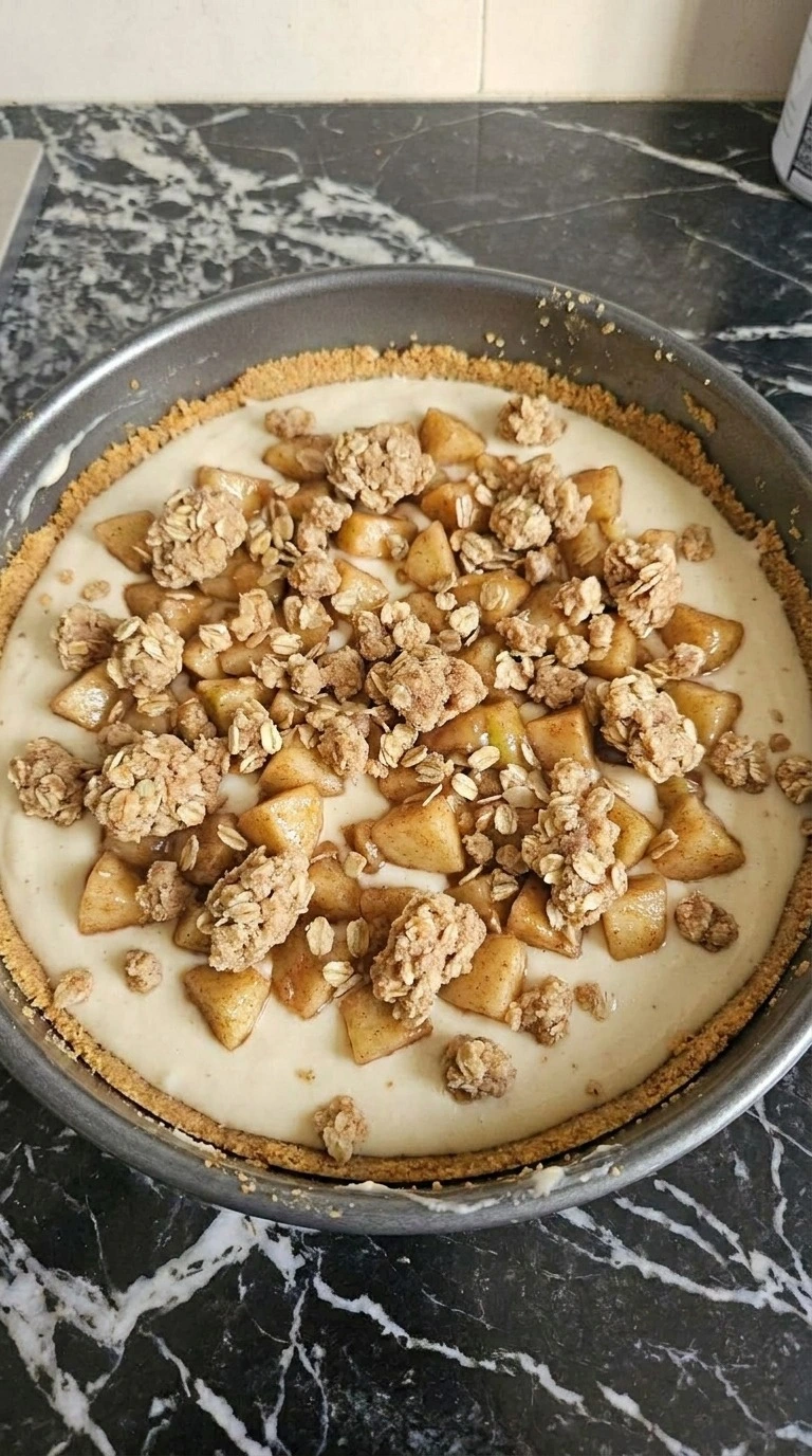 Apple Crisp Cheesecake layered with creamy filling, cinnamon apples and oat streusel Recipe focus: apple crisp recipe easy simple.