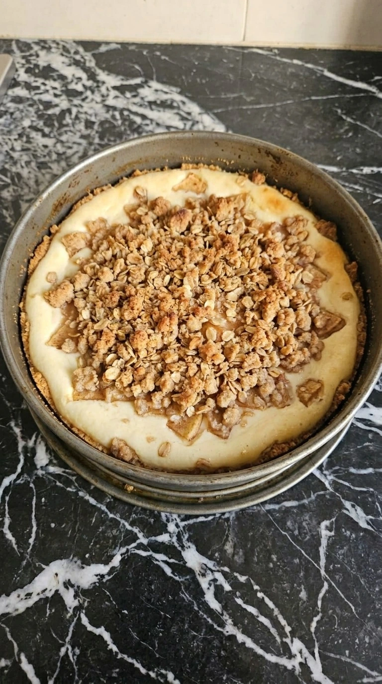 Apple Crisp Cheesecake baked with deep golden oat streusel and visible cinnamon apples Recipe focus: homemade apple crisp easy.