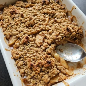 Apple Crisp with Oatmeal Crumble baked with deep-golden oat clusters and visible cinnamon apple slices Recipe focus: oatmeal crumble topping apple crisp.