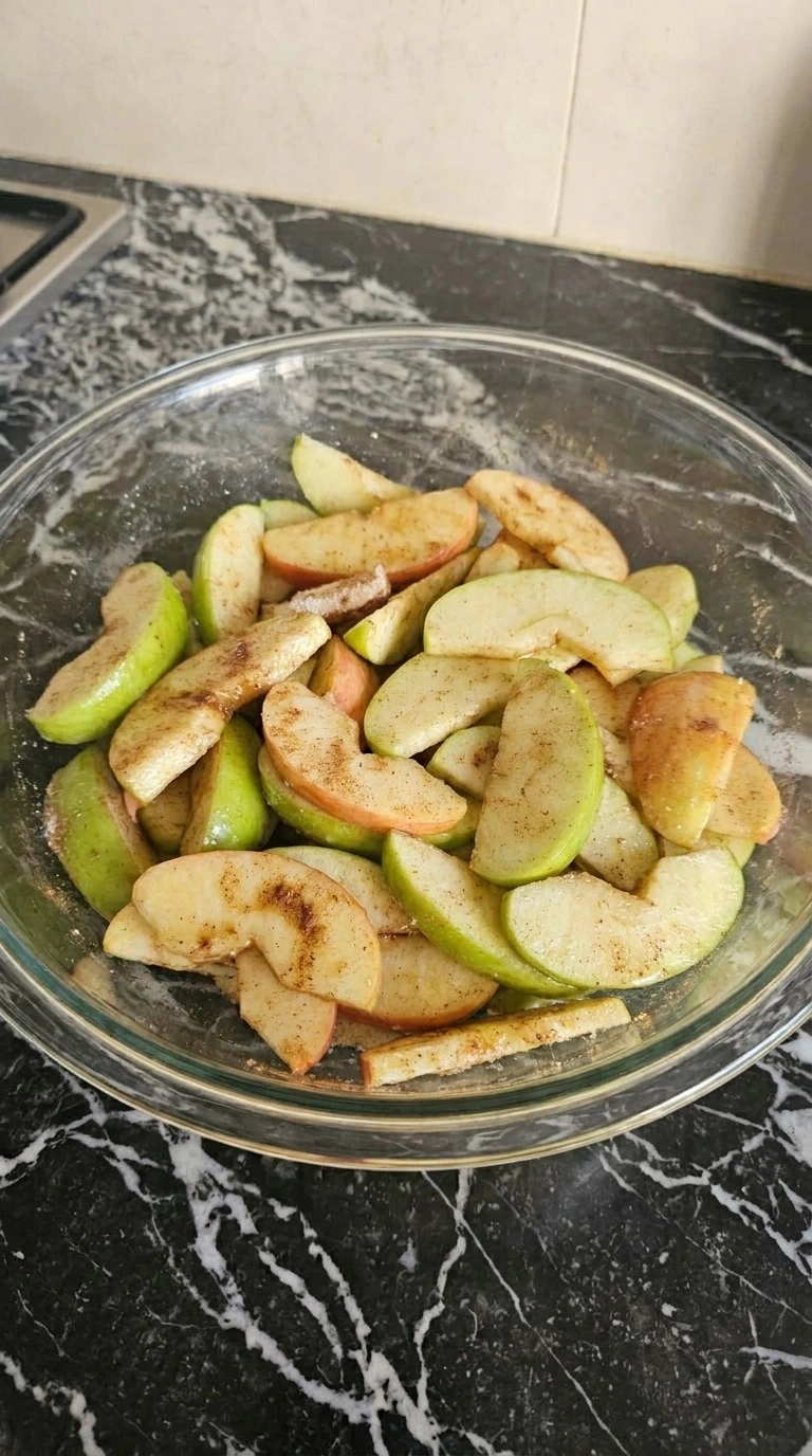 Apple Crisp with Oatmeal Crumble step 1: slice and coat the apples with visible texture changes Recipe focus: best apple crumble recipe.